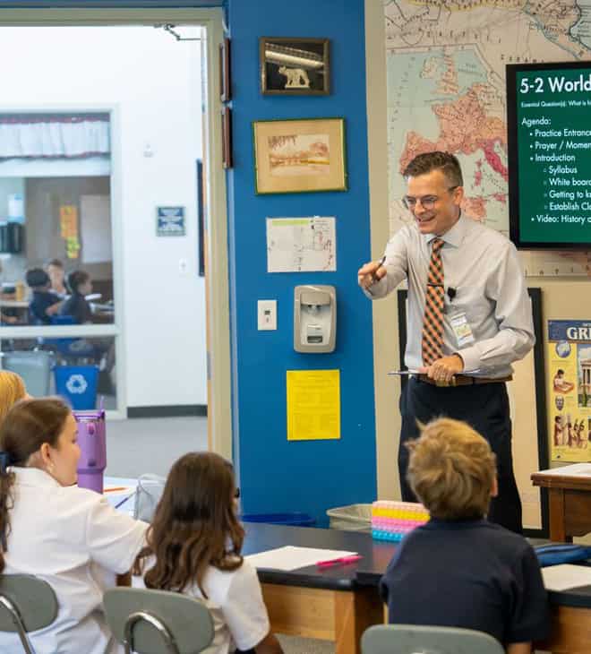 Teacher pointing to student in history class